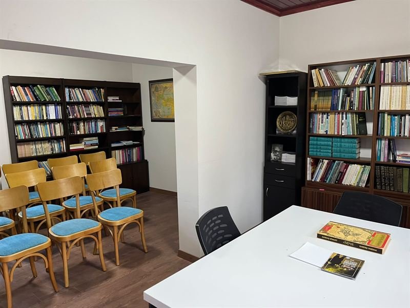 Kütüphanede çalışma masası ve kitaplıklar